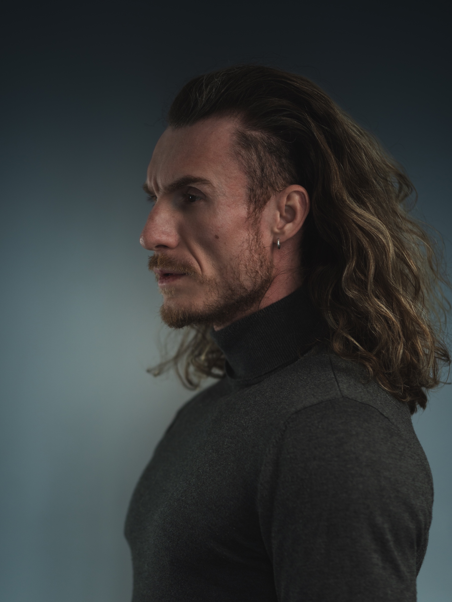 Adi Gheo Romanian actor left profile with long hair